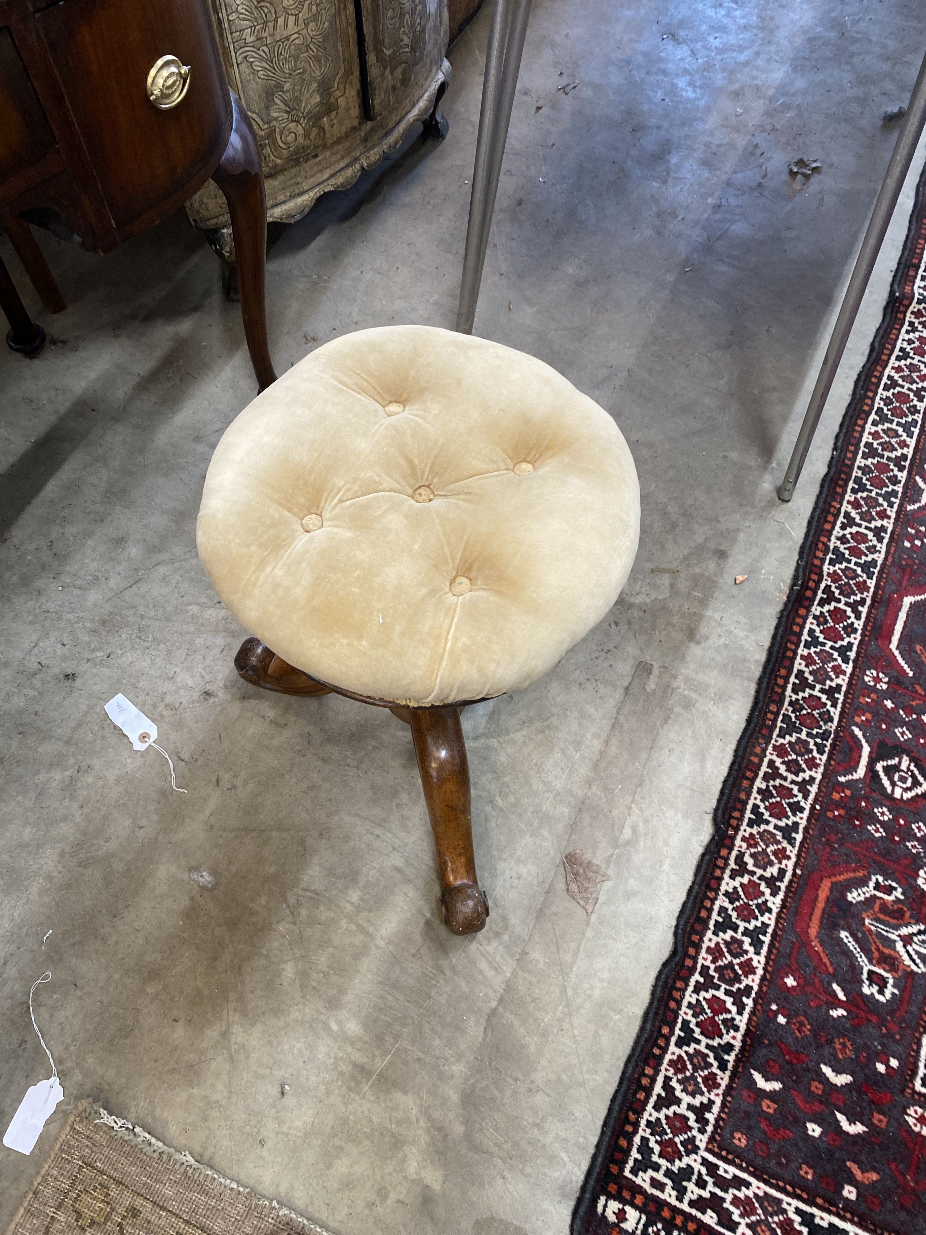 A Victorian oak revolving piano stool